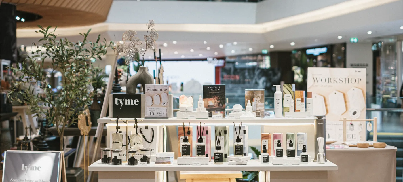 The Tyme counter, with diffusers and skin care arranged on light wood